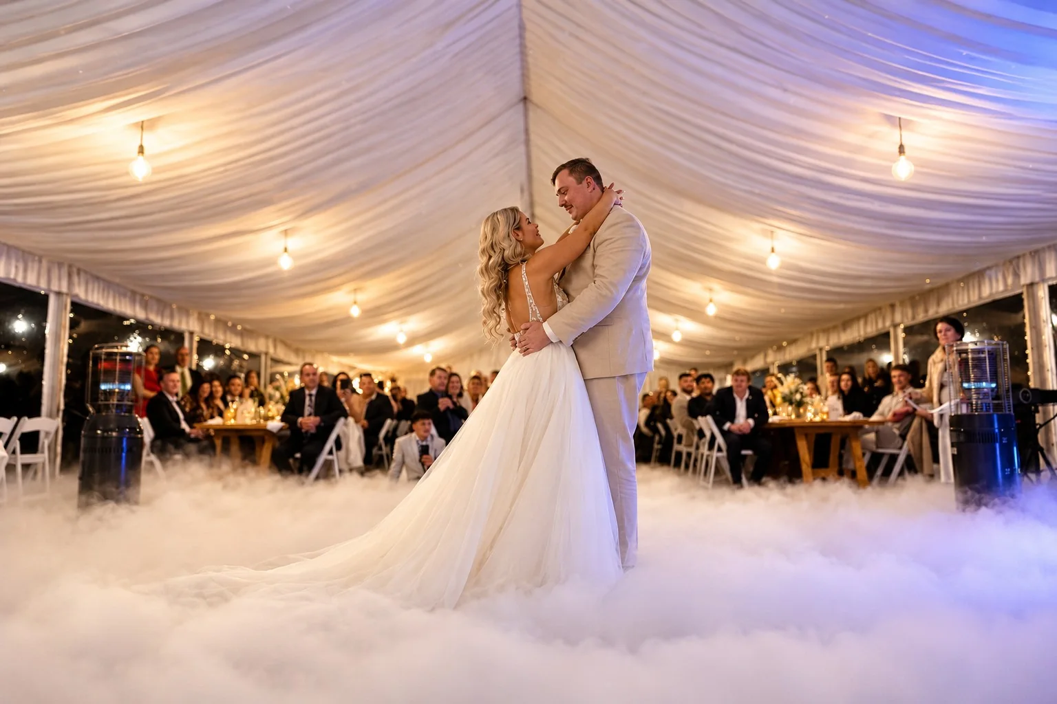 Bride and groom sharing their first dance on low lying clouds